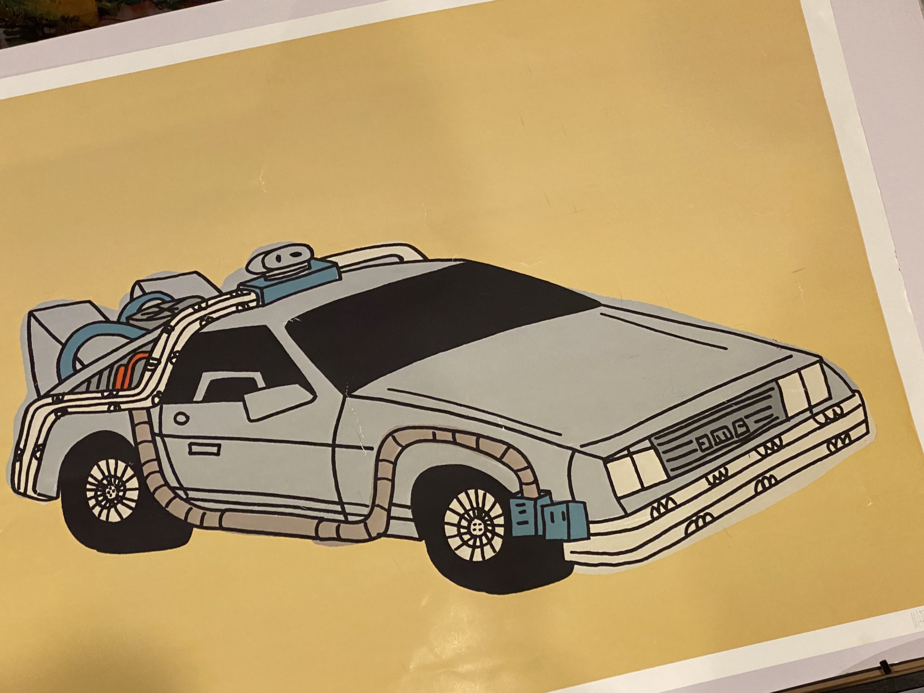 Rare Marz Jr. signed pop art of DMC DeLorean, framed and colorful, showcasing nostalgic design.